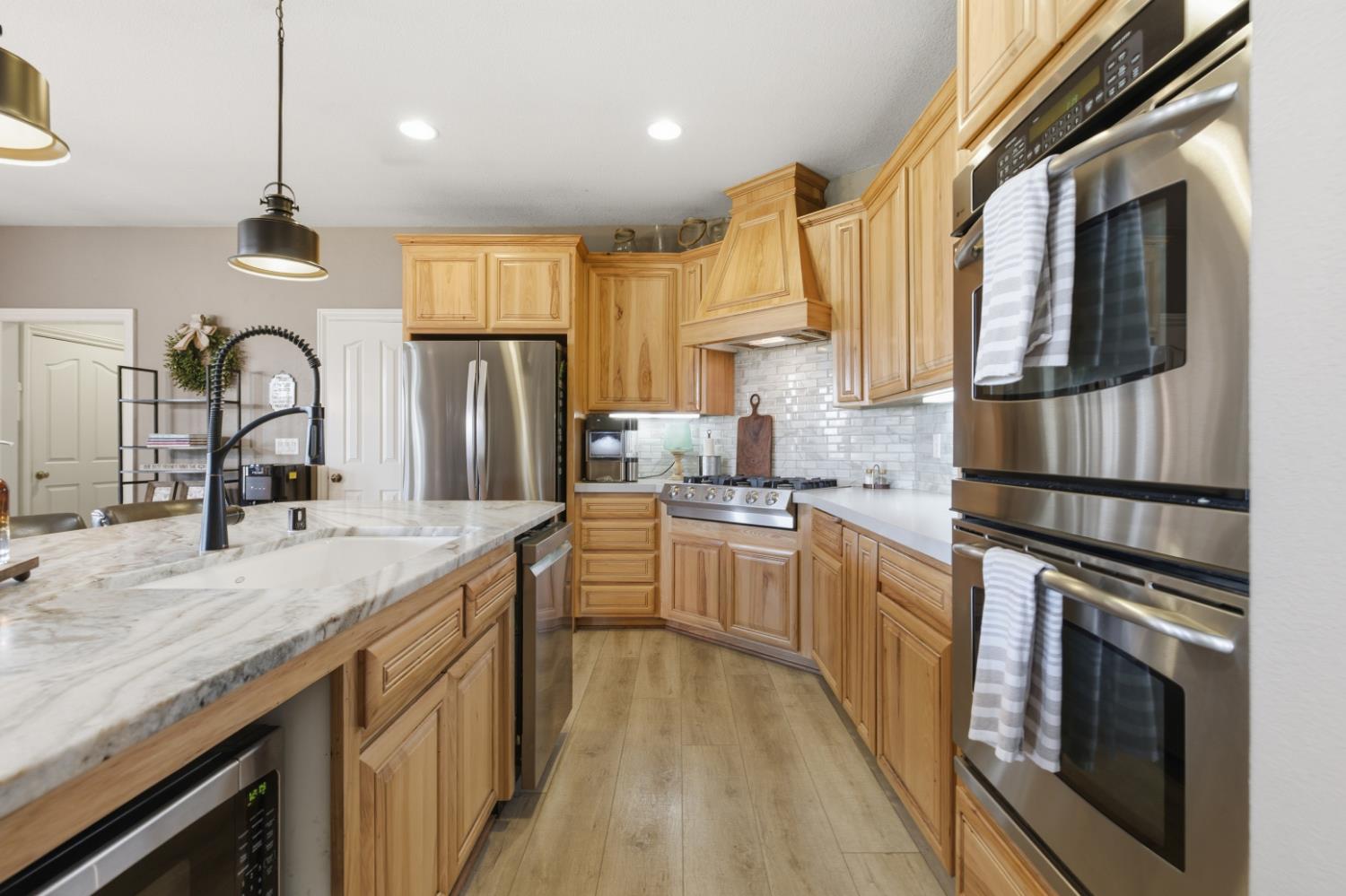 3302 Bear River Drive Rio Oso, CA 95674 - Photo 7 of 93 a kitchen with stainless steel appliances granite countertop hardwood floor sink stove and refrigerator