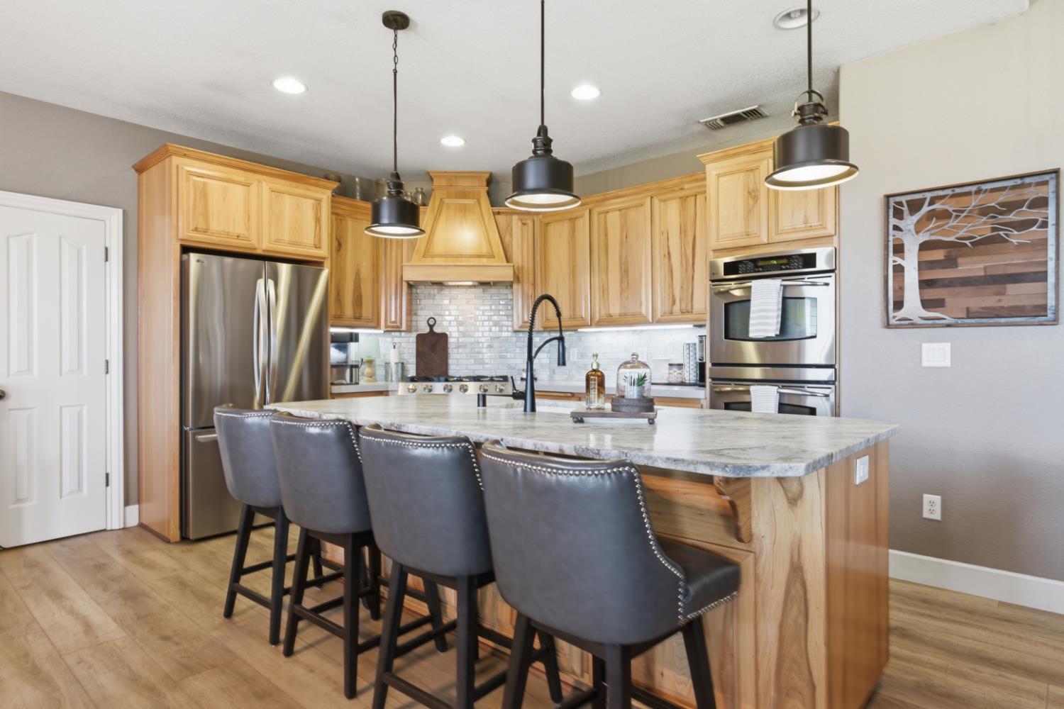 3302 Bear River Drive Rio Oso, CA 95674 - Photo 8 of 93 a kitchen with stainless steel appliances granite countertop a kitchen island a stove a sink a dining table and chairs