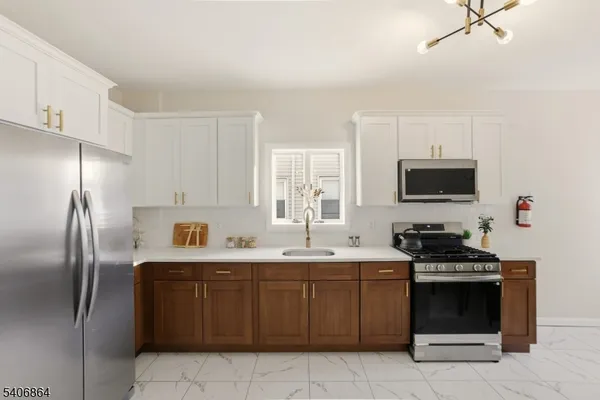 a kitchen with a sink appliances and cabinets