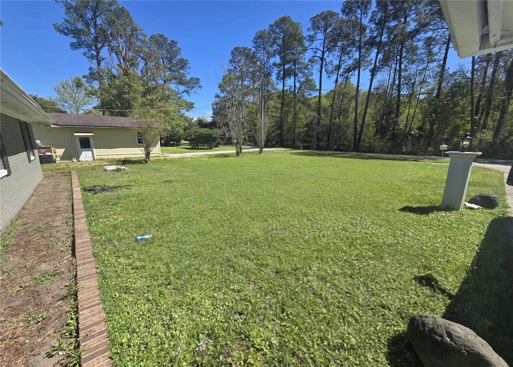 9989 Leahy Road Jacksonville, FL 32246 - Photo 18 of 21 a view of a house with a yard