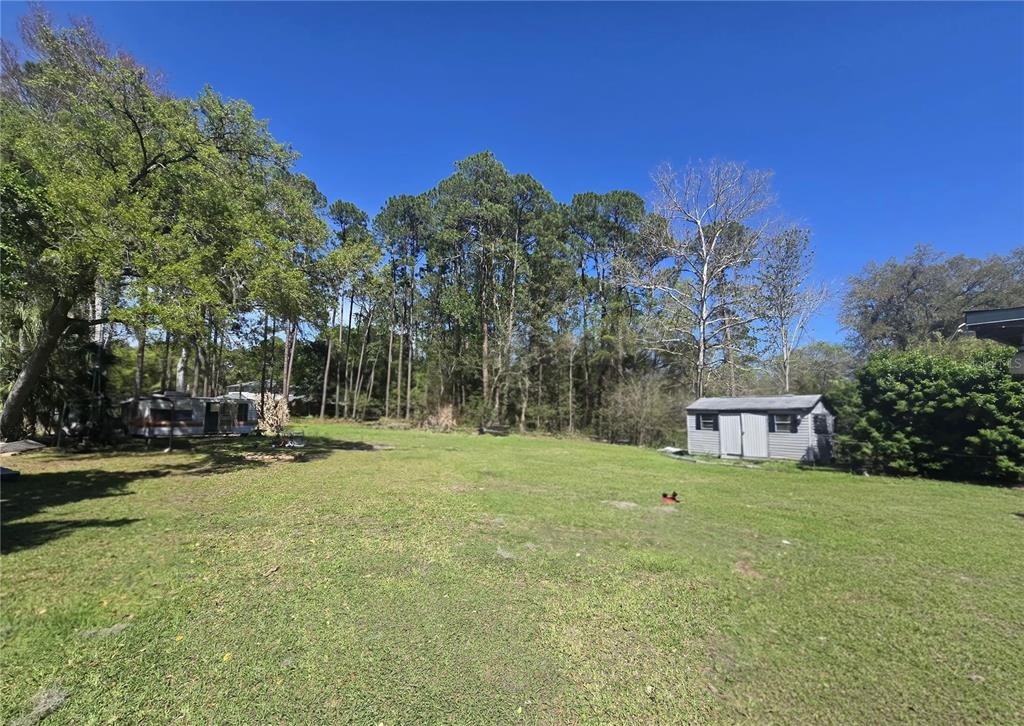 9989 Leahy Road Jacksonville, FL 32246 - Photo 21 of 21 a view of a house with a yard and sitting area