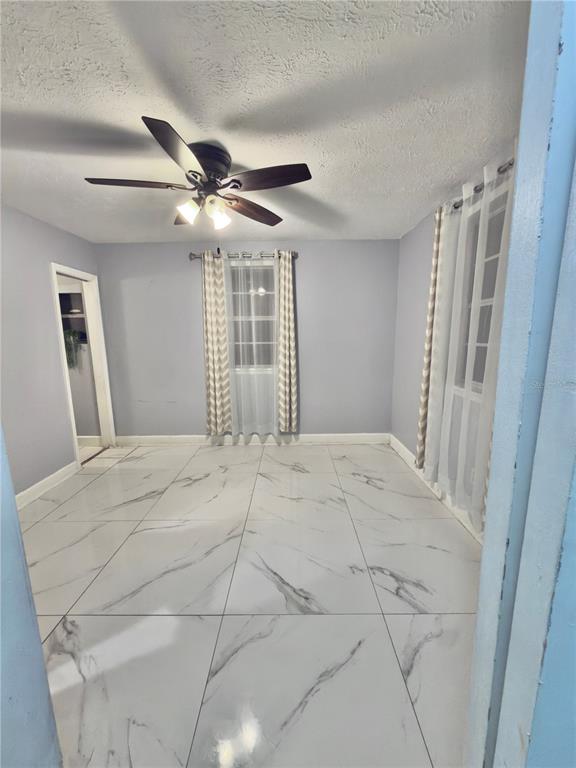 9989 Leahy Road Jacksonville, FL 32246 - Photo 6 of 21 a view of a livingroom with a ceiling fan and window