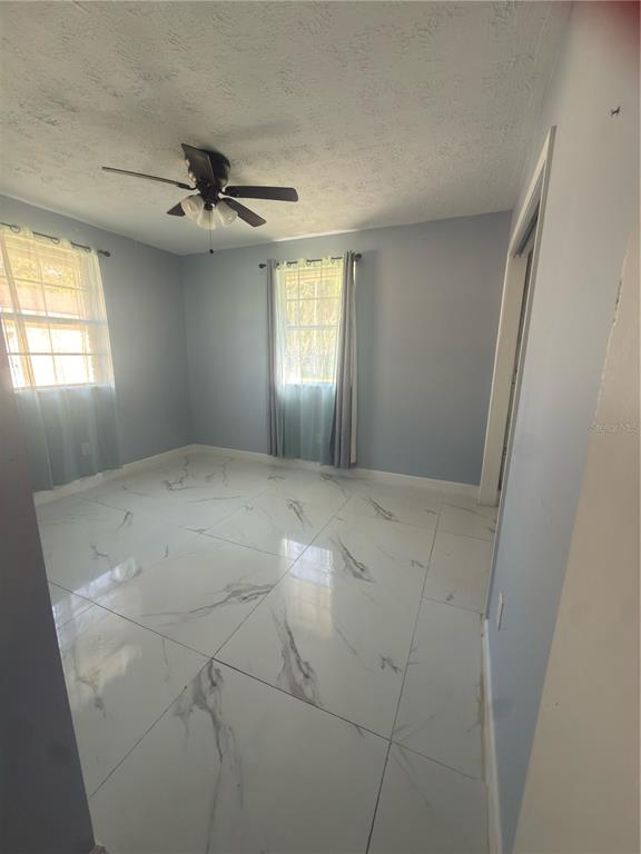 9989 Leahy Road Jacksonville, FL 32246 - Photo 7 of 21 a view of an empty room and a window
