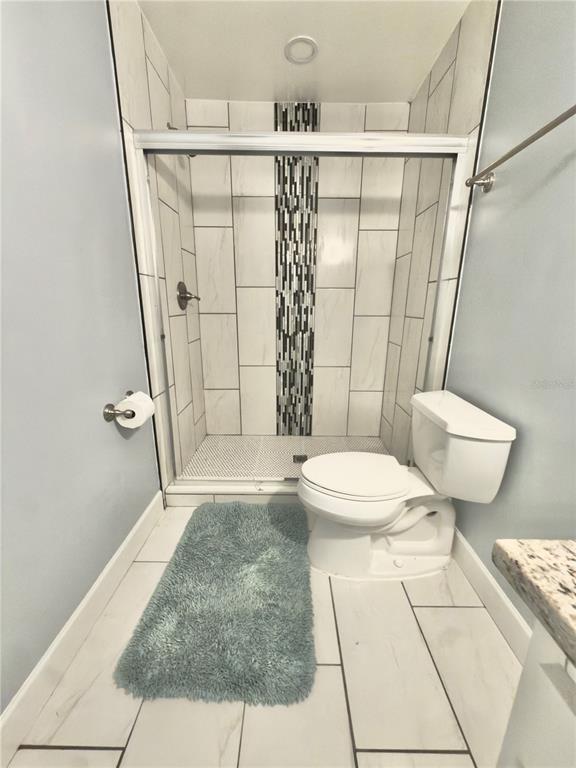 9989 Leahy Road Jacksonville, FL 32246 - Photo 8 of 21 a bathroom with a sink toilet and shower