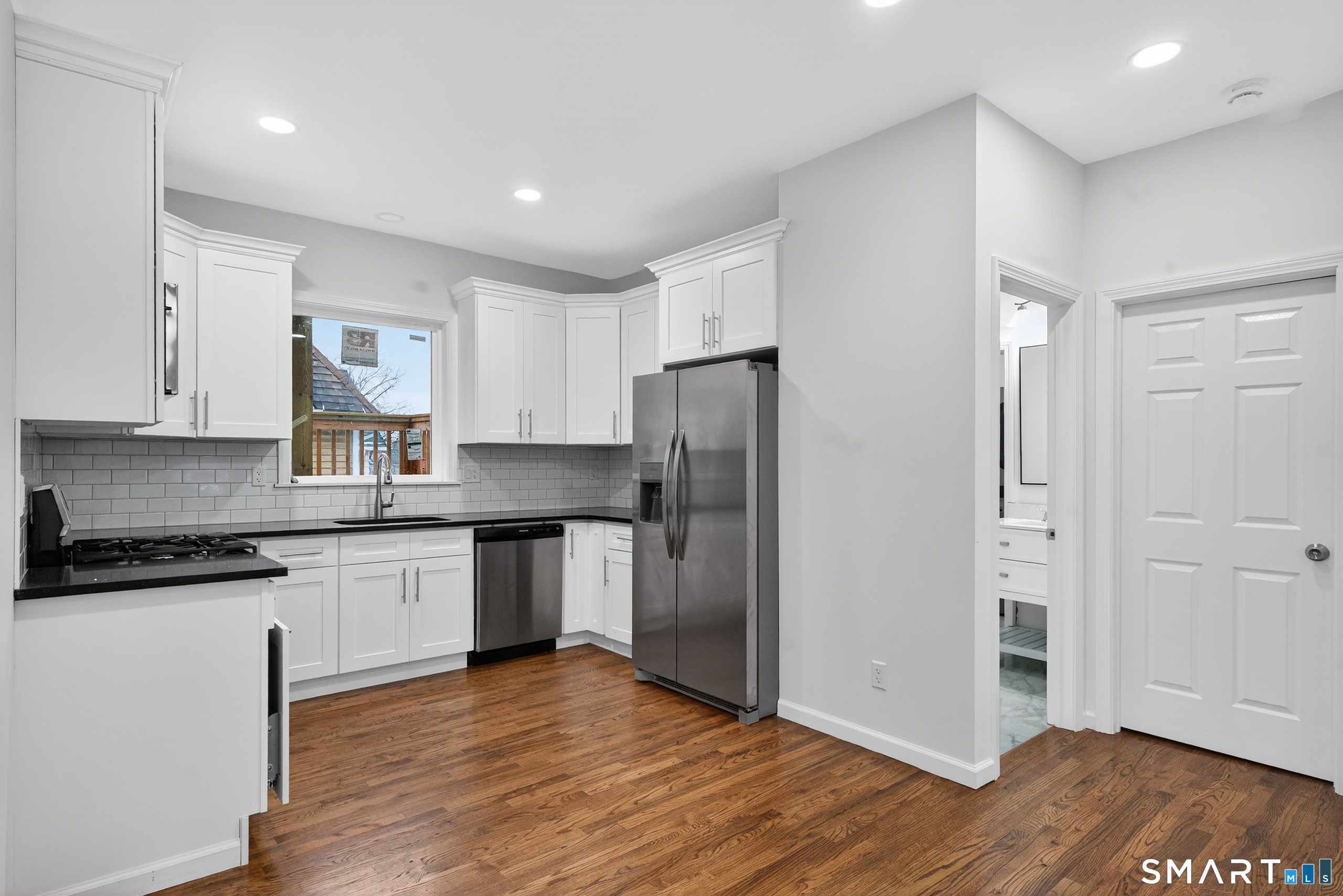 144 Cottage Street, Unit 2 Bridgeport, CT 06605 - Photo 1 of 12 a kitchen with granite countertop stainless steel appliances a refrigerator and cabinets