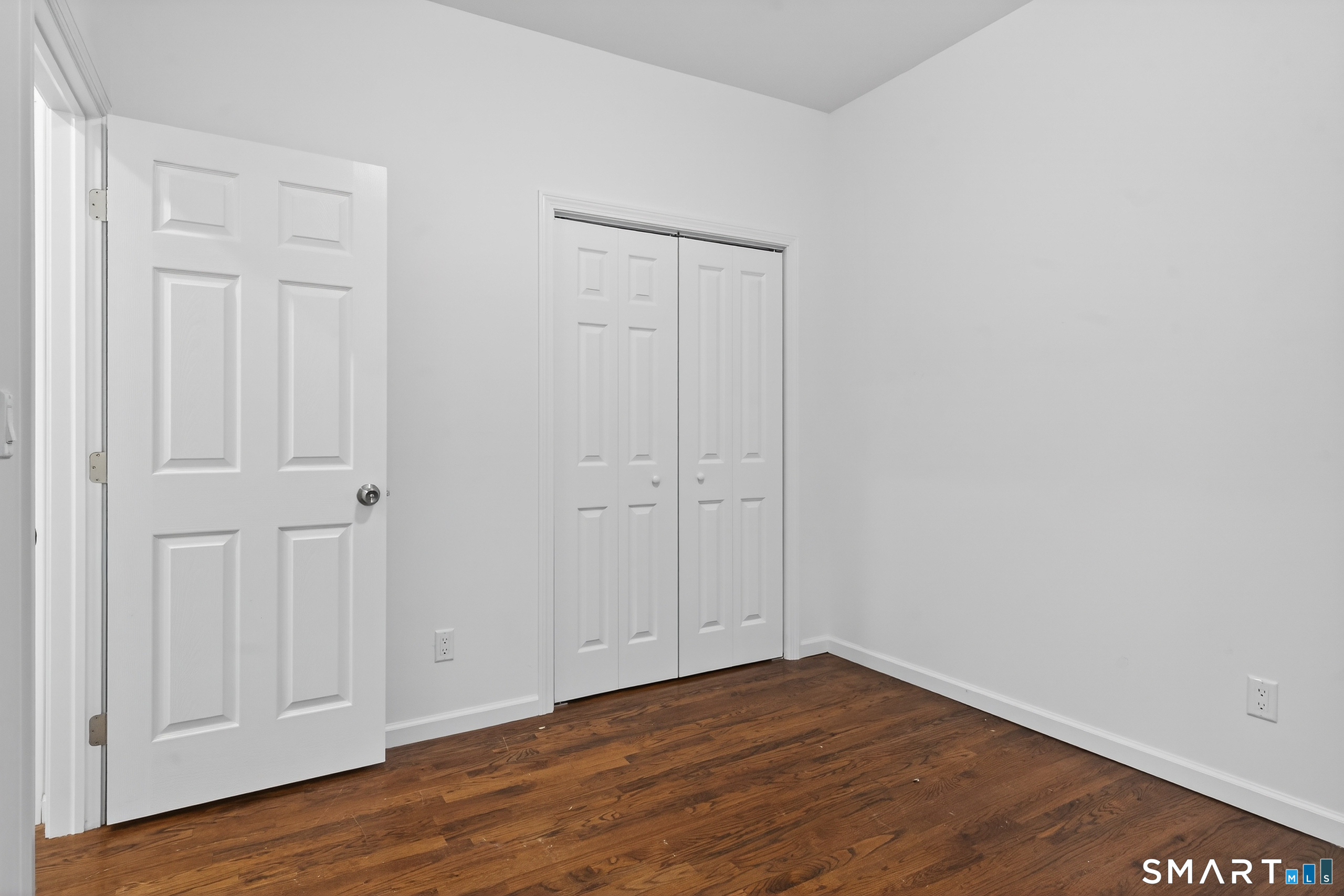 144 Cottage Street, Unit 2 Bridgeport, CT 06605 - Photo 11 of 12 a view of an empty room with wooden floor
