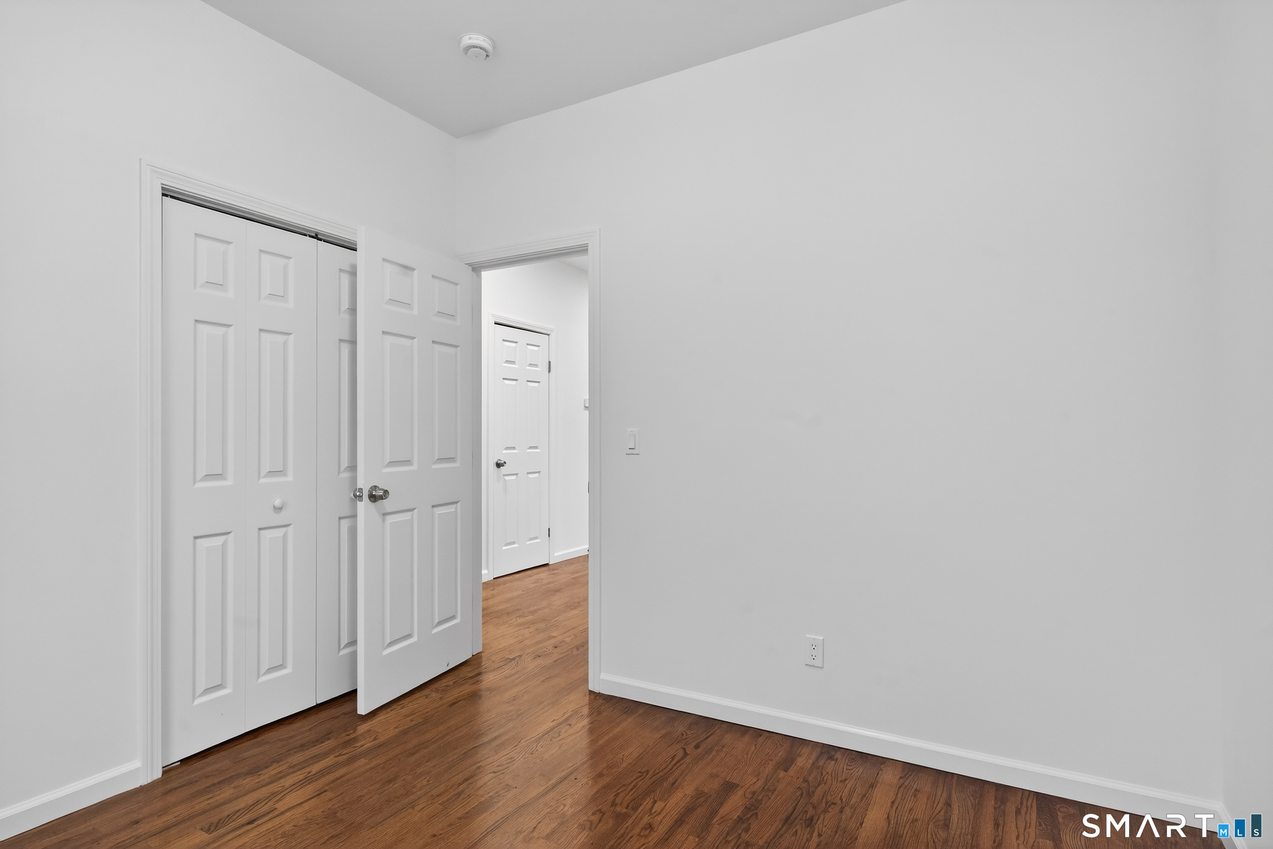 144 Cottage Street, Unit 2 Bridgeport, CT 06605 - Photo 3 of 12 a view of a hallway with wooden floor