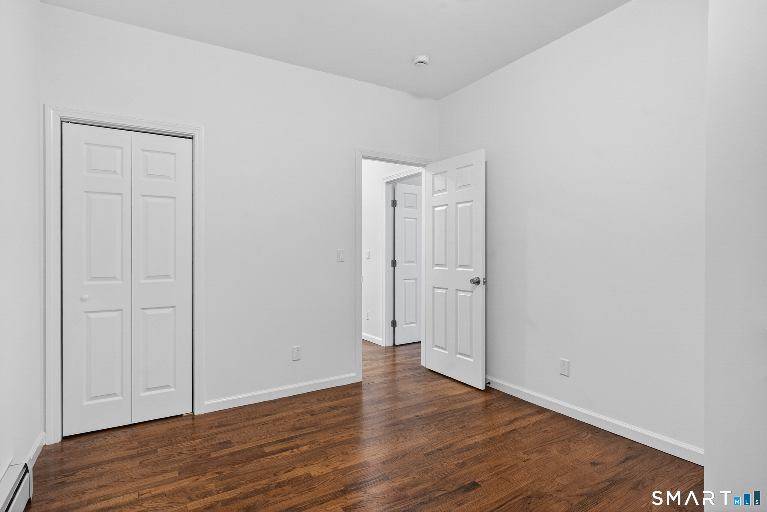 144 Cottage Street, Unit 2 Bridgeport, CT 06605 - Photo 5 of 12 a view of empty room with wooden floor