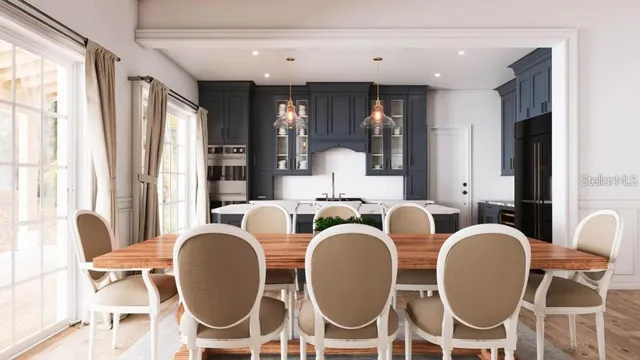 a dining room with wooden floor and windows