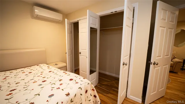 a bedroom with a bed and a mirror