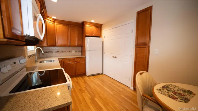 a view of a kitchen with a sink a refrigerator and a stove