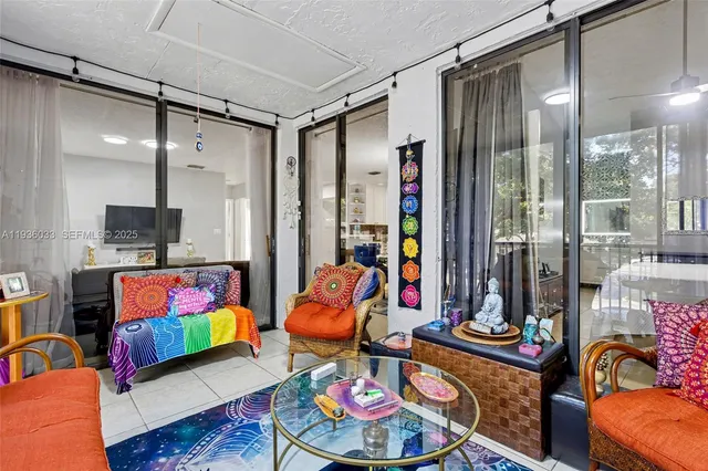 a living room with lots of furniture and painting on the wall