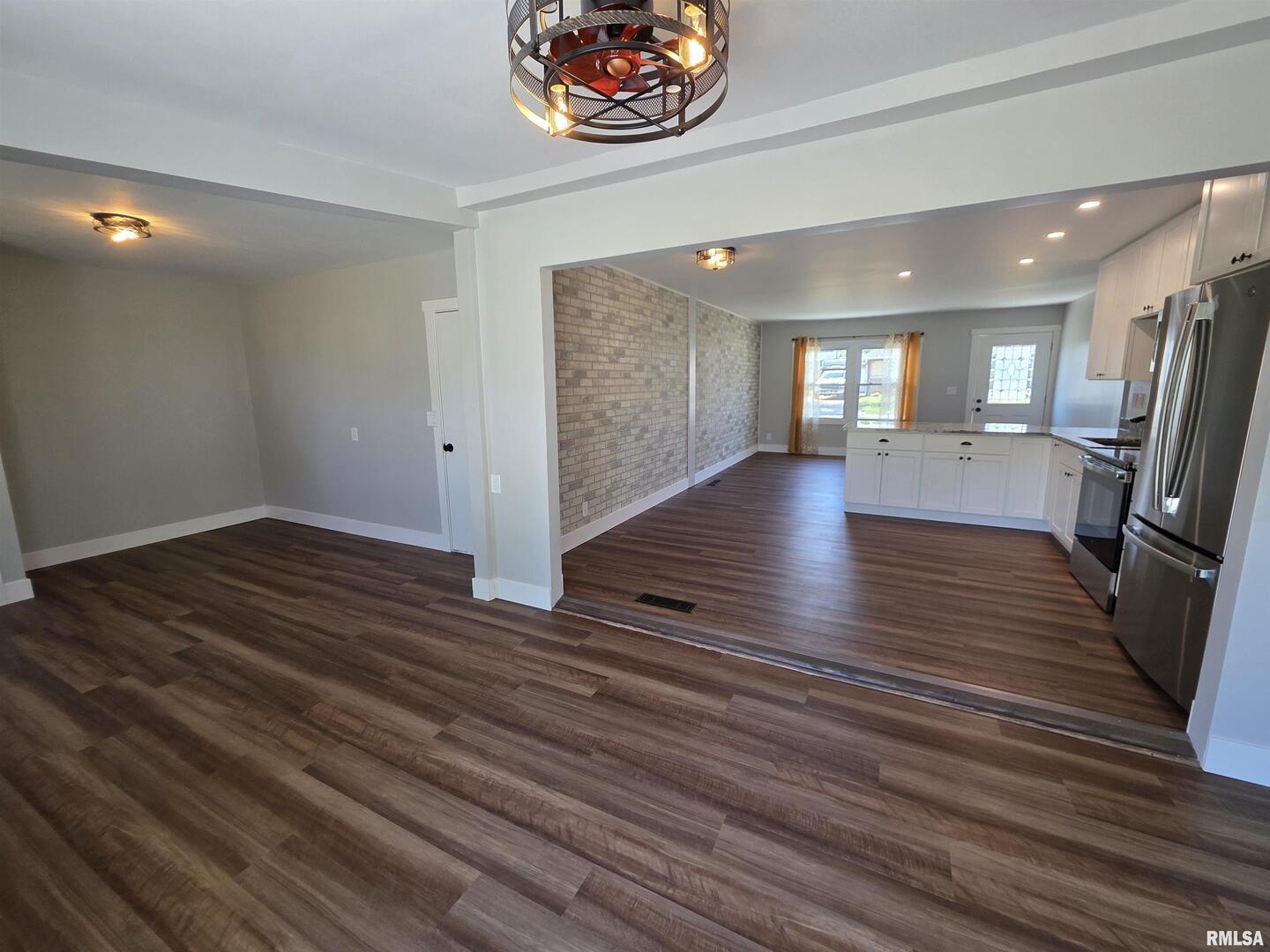 1031 Galbraith Drive Clinton, IA 52732 - Photo 16 of 35 an empty room with wooden floor and windows