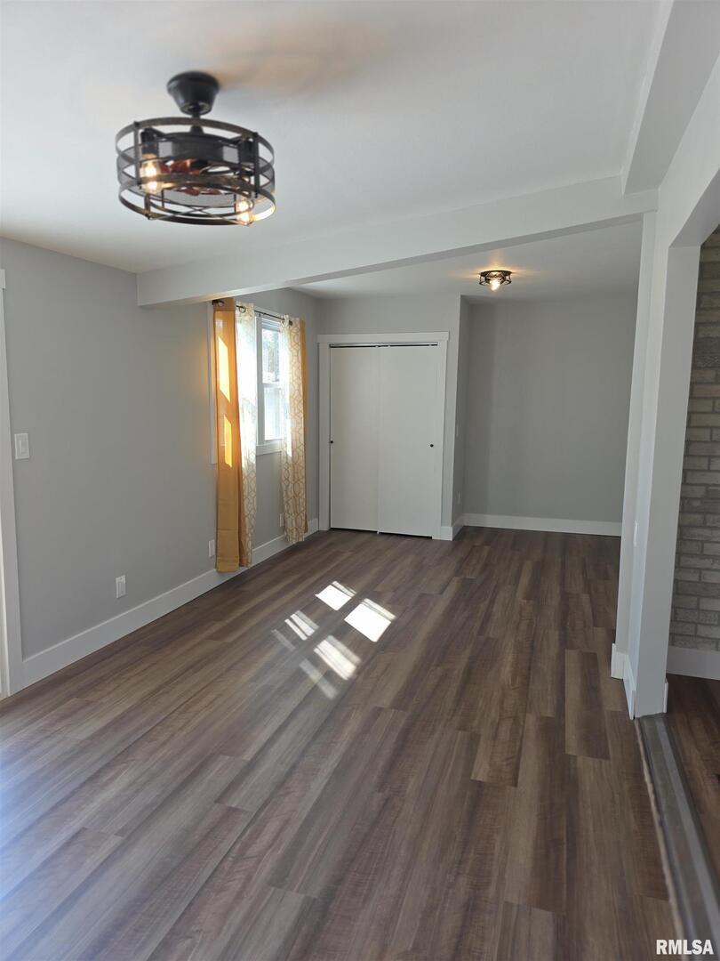 1031 Galbraith Drive Clinton, IA 52732 - Photo 18 of 35 wooden floor in an empty room with a window