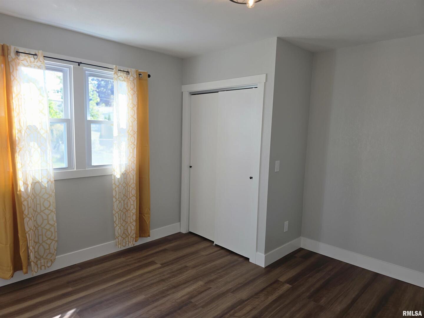 1031 Galbraith Drive Clinton, IA 52732 - Photo 19 of 35 a view of an empty room with wooden floor and a window