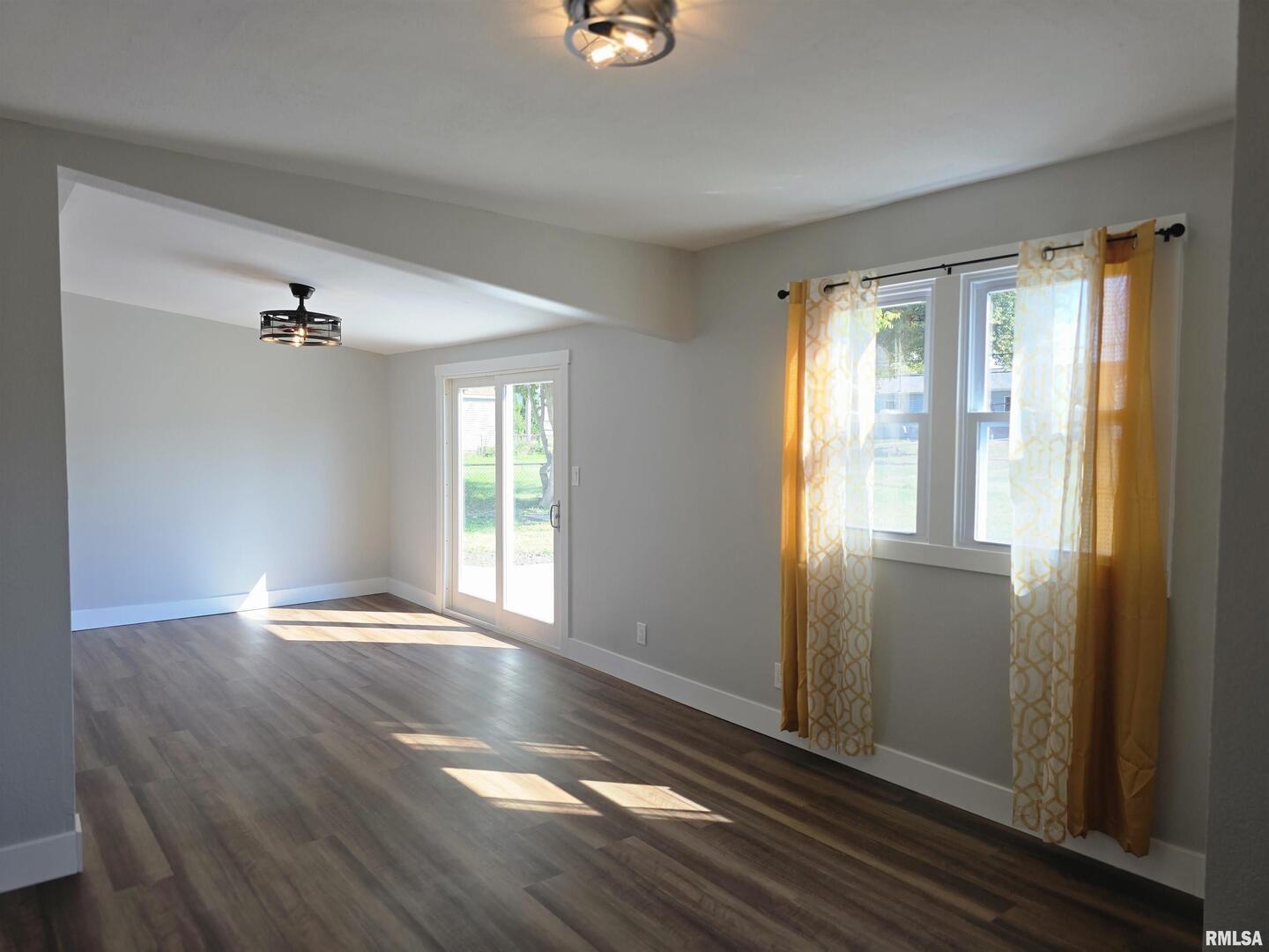 1031 Galbraith Drive Clinton, IA 52732 - Photo 22 of 35 a view of an empty room with wooden floor and a window