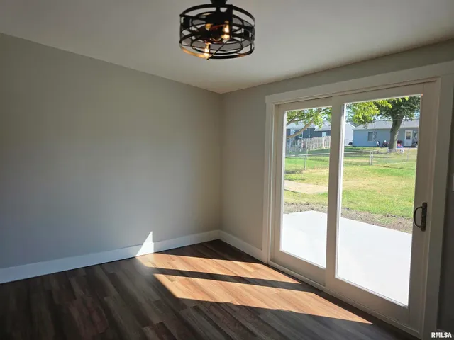 a view of a refrigerator in kitchen and wooden floor