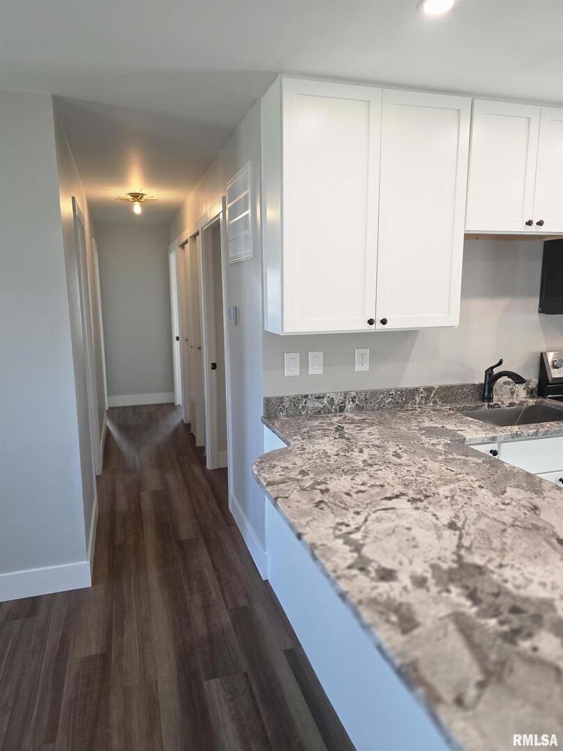 1031 Galbraith Drive Clinton, IA 52732 - Photo 24 of 35 a view of a refrigerator in kitchen and wooden floor
