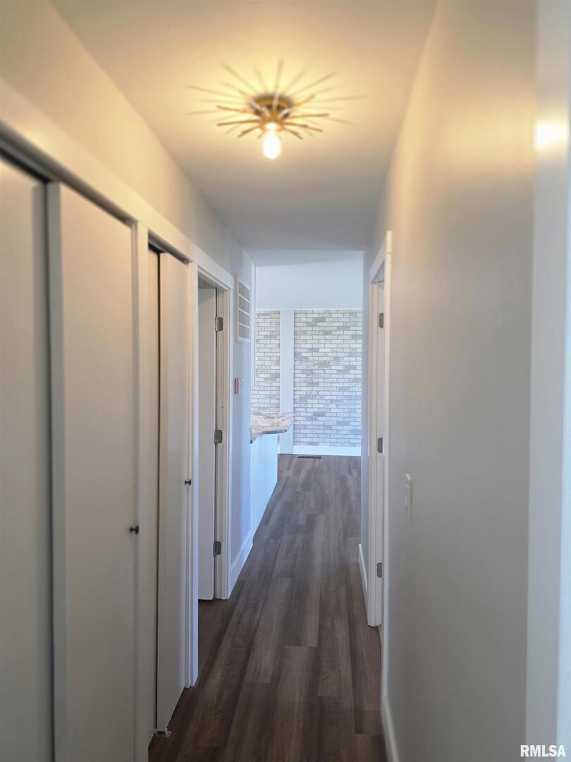 1031 Galbraith Drive Clinton, IA 52732 - Photo 25 of 35 a view of a hallway with wooden floor and a chandelier