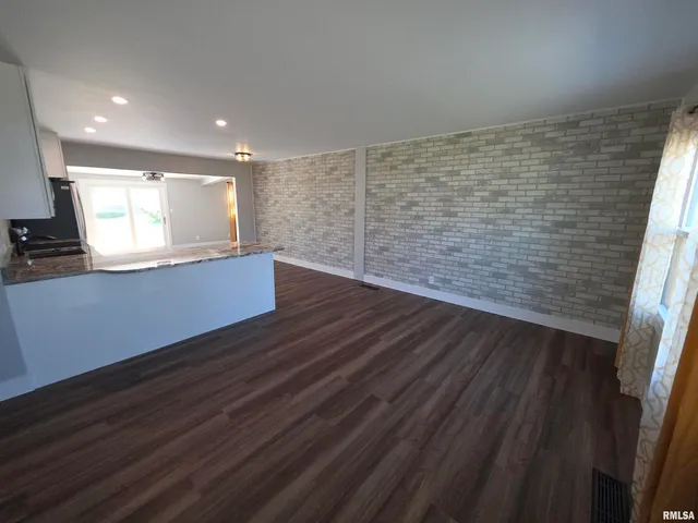 a view of kitchen with wooden floor and window