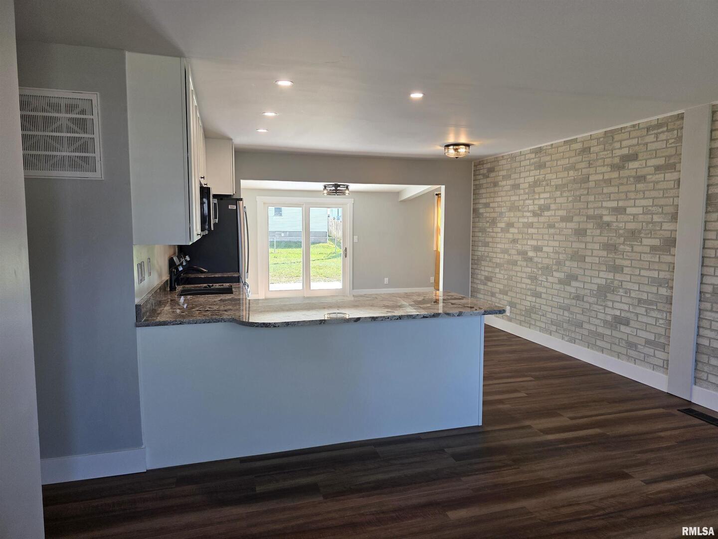 1031 Galbraith Drive Clinton, IA 52732 - Photo 5 of 35 a view of kitchen with wooden floor and window