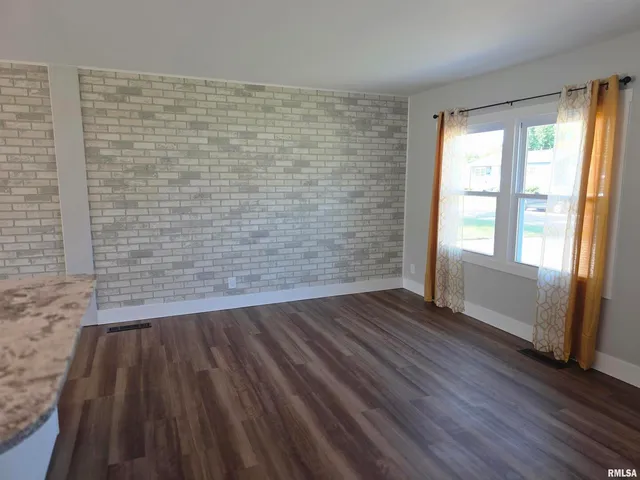 a view of wooden floor with window in an empty room