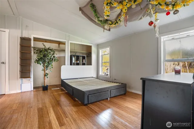 a spacious bedroom with a bed and a table in it