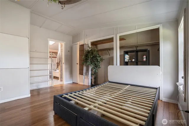 a view of a livingroom with wooden floor and stairs