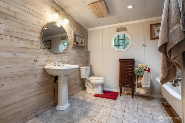 a bathroom with a sink toilet and a mirror