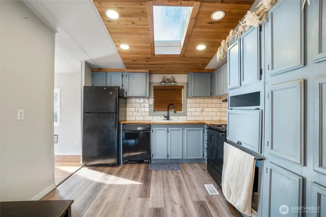 a kitchen with stainless steel appliances a refrigerator and a stove