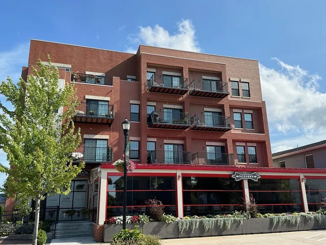 a front view of a residential apartment building with a yard