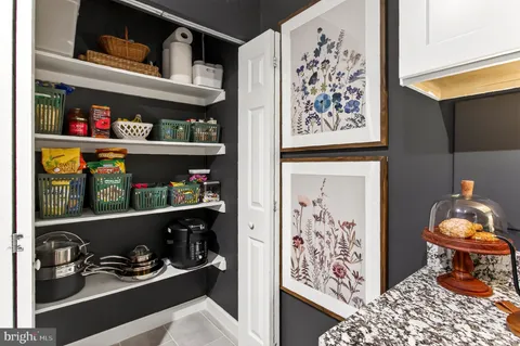 a room with lots of books and a painting on the wall