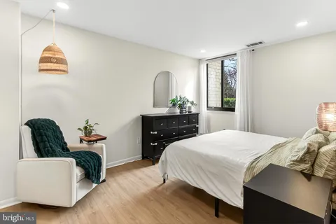 a bedroom with a bed and a dresser