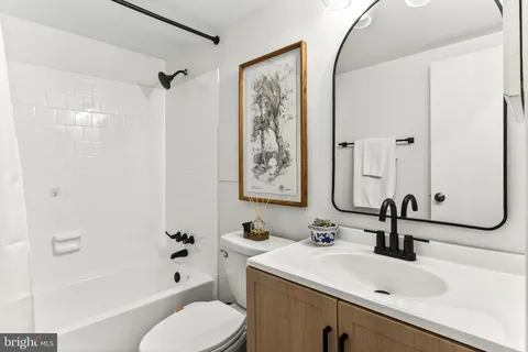 a bathroom with a sink toilet tub and shower