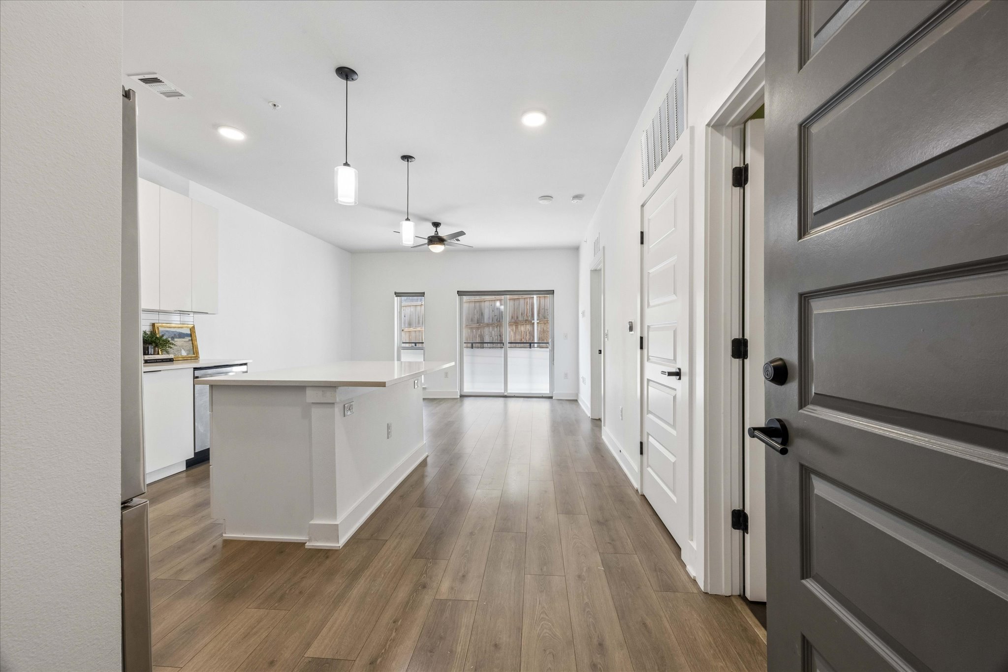 2220 Webberville Road, Unit 216 Austin, TX 78702 - Photo 2 of 26 Open-concept kitchen and living area with wood-finish flooring extending from the entry