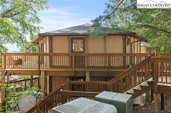 a view of a house with wooden deck