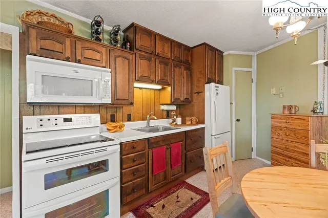 a kitchen with a stove oven and sink