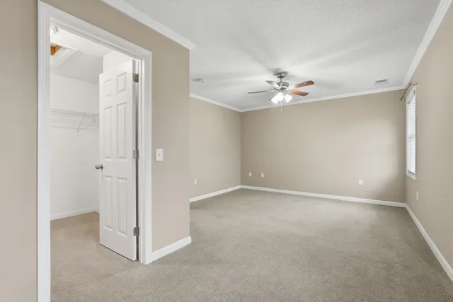 a view of an empty room with a ceiling fan