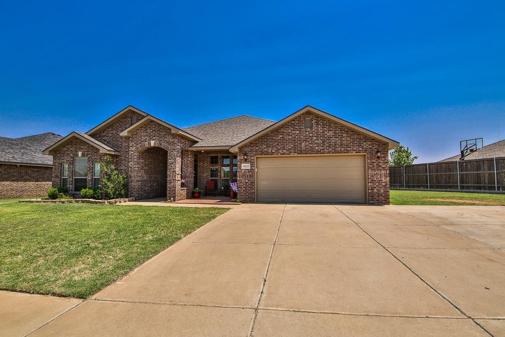 9103 Rochester Avenue Lubbock, TX 79424 - Photo 2 of 26 a front view of a house with a yard