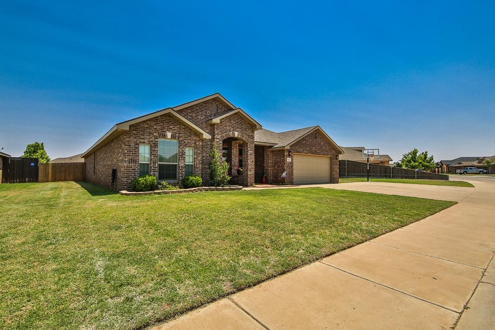 9103 Rochester Avenue Lubbock, TX 79424 - Photo 3 of 26 a view of a house with a yard