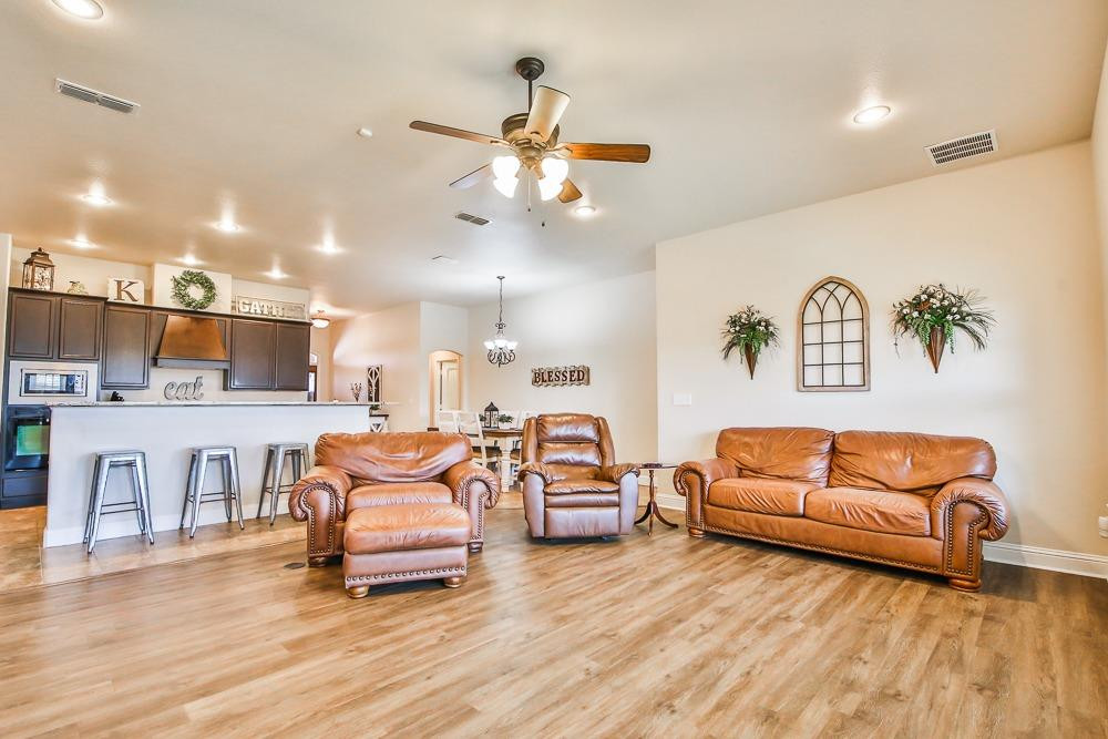 9103 Rochester Avenue Lubbock, TX 79424 - Photo 8 of 26 a living room with furniture and kitchen view