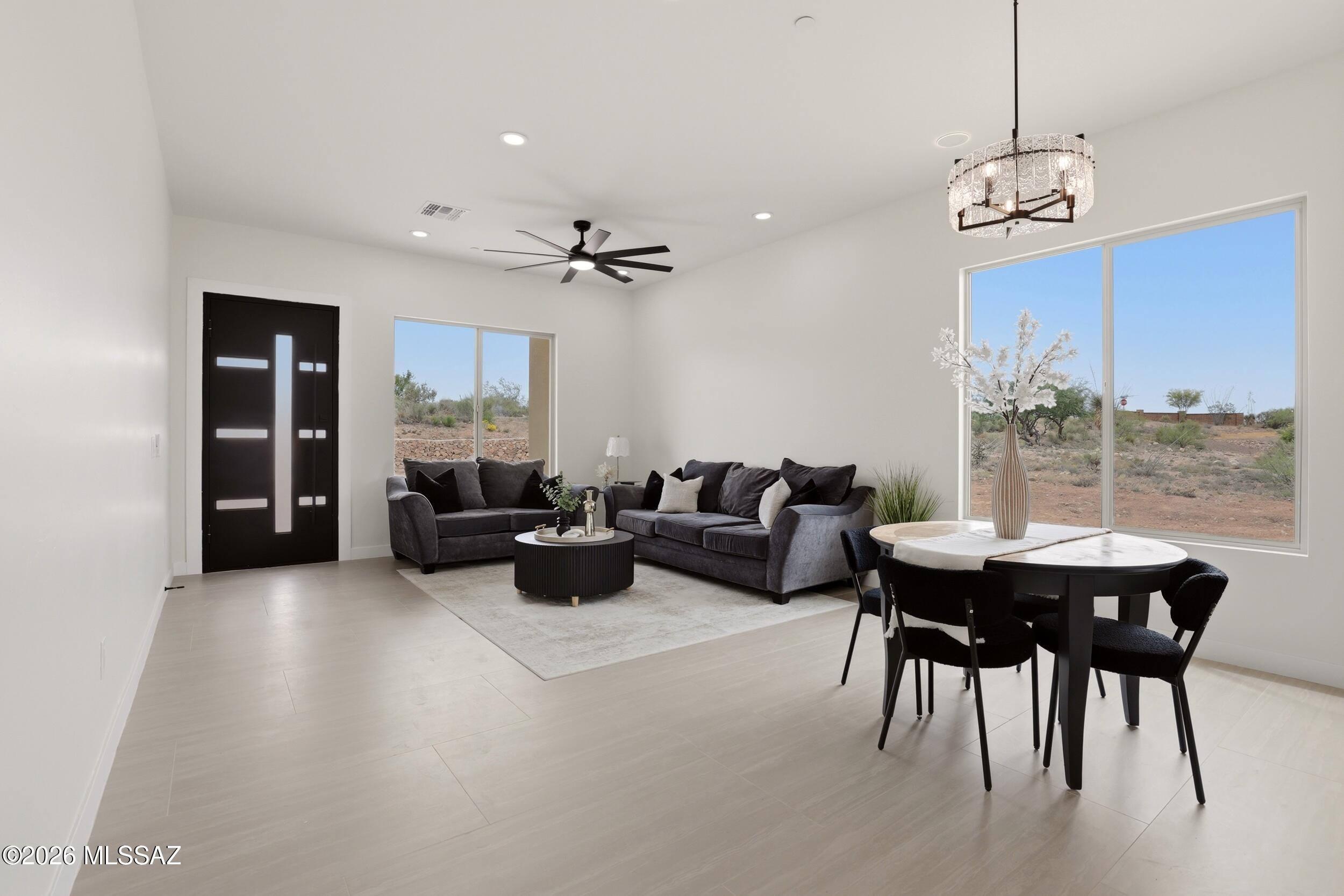 14527 East Sands Ranch Road Vail, AZ 85641 - Photo 19 of 48 a living room with furniture a chandelier and a large window