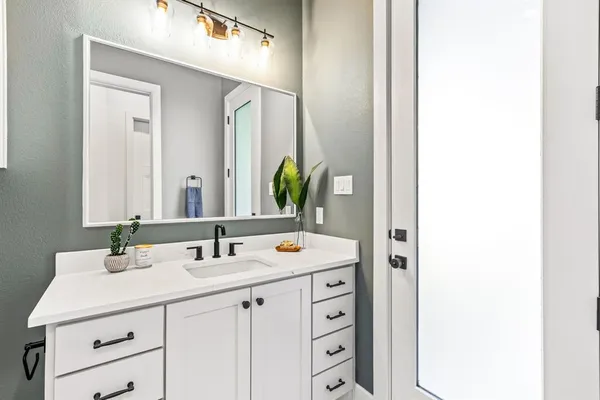 a bathroom with a sink and a mirror
