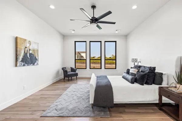 a bedroom with a bed and glass window