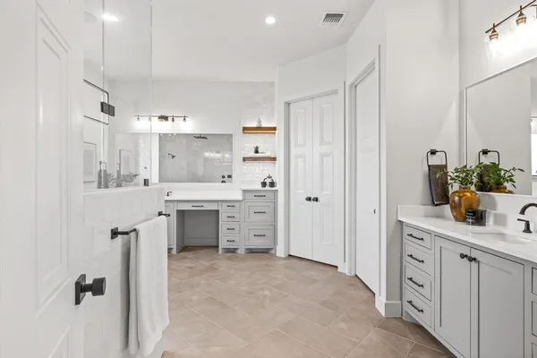 a kitchen with white cabinets and counter space