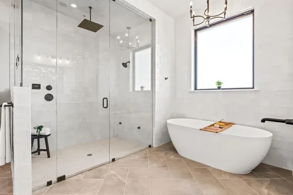 a bathroom with a tub and shower