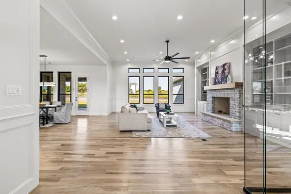 a living room with fireplace furniture and a wooden floor