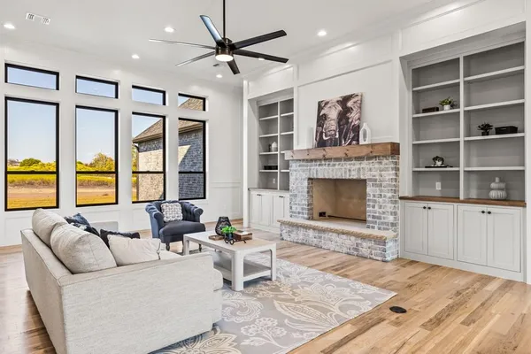 a living room with furniture a window and a fireplace