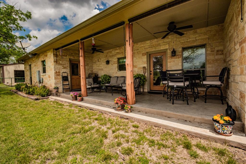 2657 West Sabinal Road Utopia, TX 78884 - Photo 17 of 36 a view of a dinning tables and chairs in patio of the house