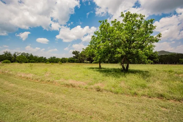 a bathroom with a sink a toilet a mirror and shower